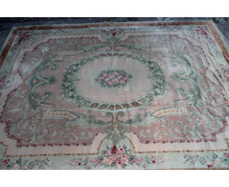 A SAVONNERIE STYLE MACHINE WOOL CARPET, 20th century, with central oval medallion of pink and yellow roses and similar spandr