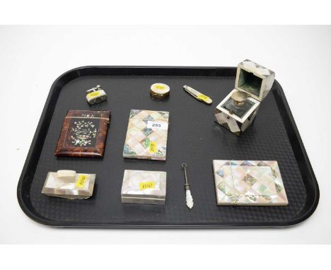 A collection of Victorian and later mother of pearl collectibles, including: two mother of pearl and abalone card cases; moth
