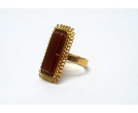 A carnelian ring, in 18ct yellow gold mount and shank, ring size L, 5.9g gross. 