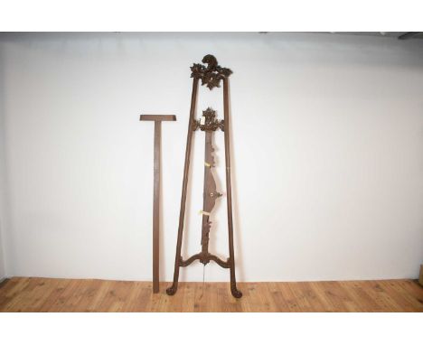 A large 20th Century mahogany artist's easel, the florally carved motifs to the stand raised on a tripod base. 60 wide x  220