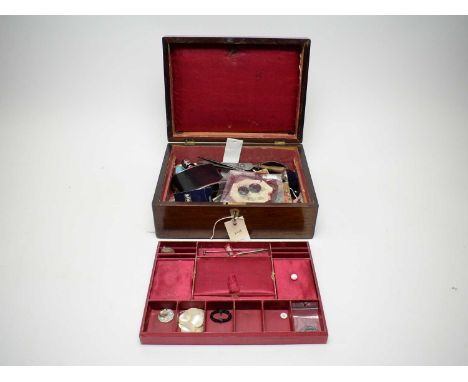 An early 20th Century rosewood workbox, the hinged lid with inset mother of pearl cartouche, opening to reveal lift out tray,