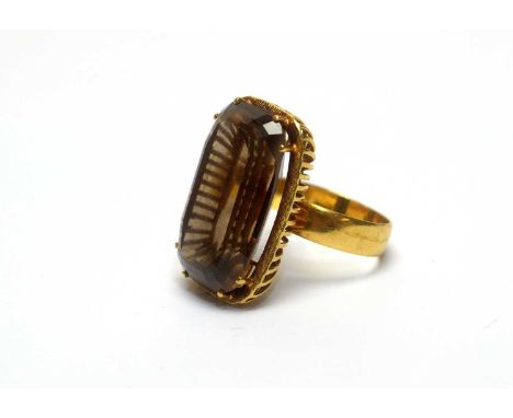 A smokey quartz ring, in 18ct yellow gold mount and shank, ring size P, 11.0g gross. 