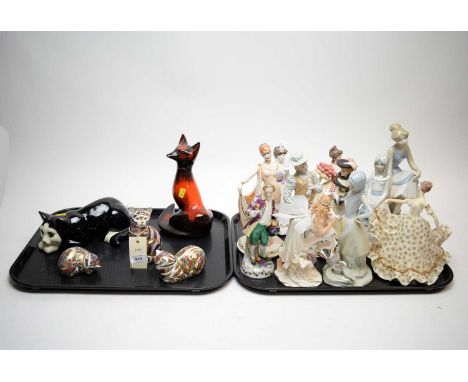 Three Royal Crown Derby ceramic cat paperweights or figures, one modelled seated upright, and two lying, the tallest 13cms hi