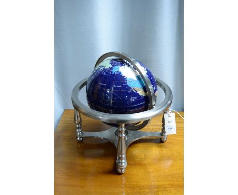 A specimen stone table globe, with abalone and other inset mineral specimens, raised on a white metal base, with four legs jo