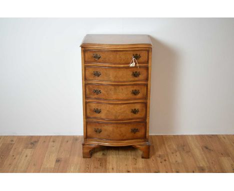 A Georgian-style burr walnut serpentine chest of drawers, the flared moulded edge over a bank of five drawers, raised on brac