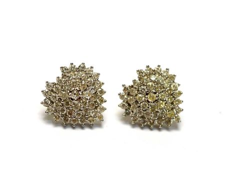 A pair of diamond earrings, of cluster heart-shaped design, set with brilliant cut diamonds in 18ct white and yellow gold, wi