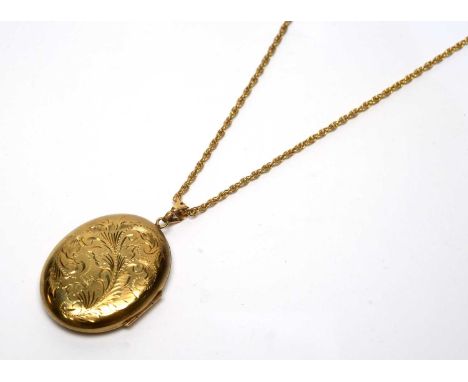 A 9ct yellow gold locket pendant, engraved with feather scrolls, on 9ct gold twist link chain, 27.5g gross.