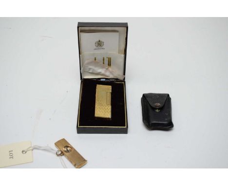 A 9ct yellow gold mounted cigar cutter, with engine turned design; and a gilt metal Dunhill lighter, cased. 