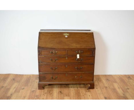 A 19th Century George III mahogany bureau, the fall front writing area opening to reveal a fully appointed interior, two shor
