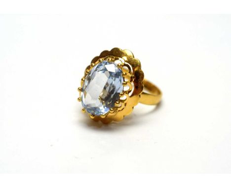A spinel ring, the oval facet cut light blue spinel in 18ct yellow gold mount and shank, ring size M, 4.6g gross.