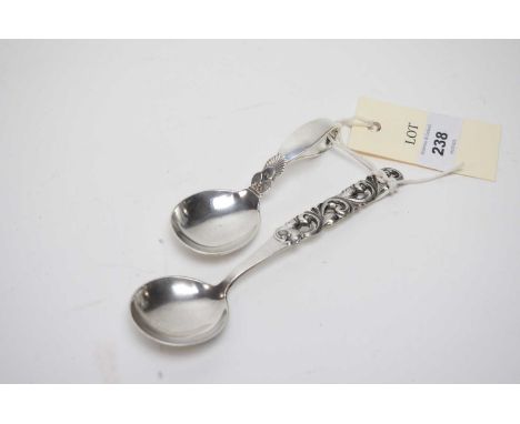 A Georg Jensen, Denmark, cactus pattern silver caddy or child's spoon; together with another spoon by Brodrene Mylius, Norway
