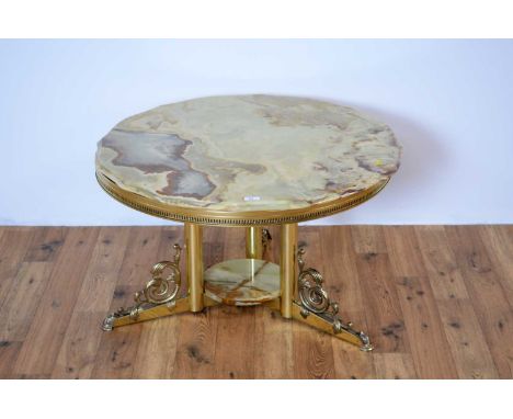 A retro vintage 20th Century onyx and brass table of circular form, the onyx tabletop with pierced support raised on a tripod