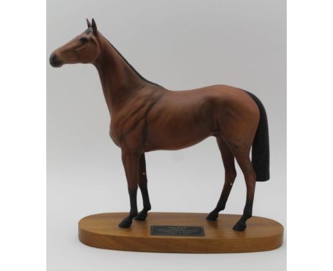 A BESWICK CONNOISSEUR CERAMIC MODEL OF 'RED RUM - winner of the Aintree grand national 1973,1974 and 1977' raised on a polish