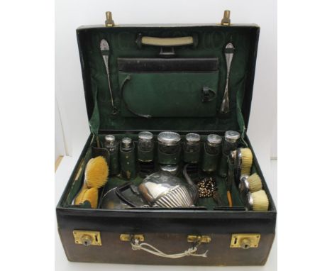 AN EARLY 20TH CENTURY GREEN LEATHER VANITY CASE, silver fitted, London 1912, contains eight hobnail cut, silver lidded jars, 