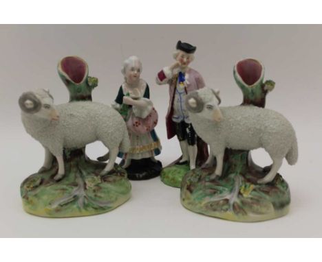 TWO 19TH CENTURY STAFFORDSHIRE POTTERY SHEEP SPILL HOLDERS, 13.5cm high, together with a pair of Continental ceramic cabinet 