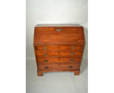 A GEORGE III MAHOGANY FALL FRONT BUREAU, the fall opens to reveal baize surface, fitted pigeonholes and drawers flanking a ce