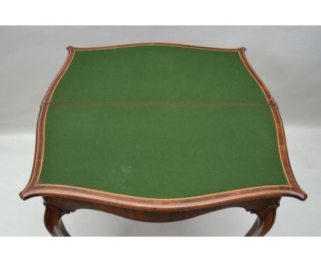 A 19TH CENTURY FRENCH FOLD OVER CARD TABLE, serpentine crossbanded with string inlay, green baize lined, opening on a concert