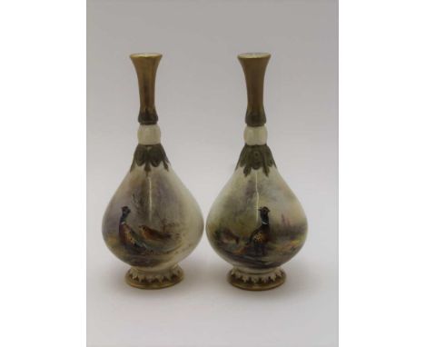 A PAIR OF ROYAL WORCESTER BONE CHINA VASES, tear drop form, painted with pheasants, in landscape by James Stinton, gilded nar