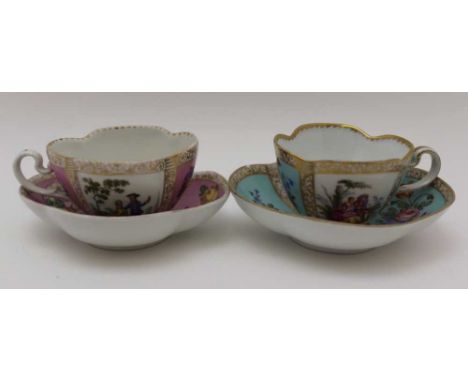 TWO GERMAN PORCELAIN CABINET CUPS & SAUCERS of serpentine form, one with alternate duck egg blue & figurative panels, undergl