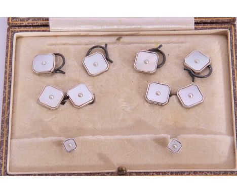 Cased gents dress studs of square form with canted corners and mother of pearl panels, each centring a small seed pearl and s