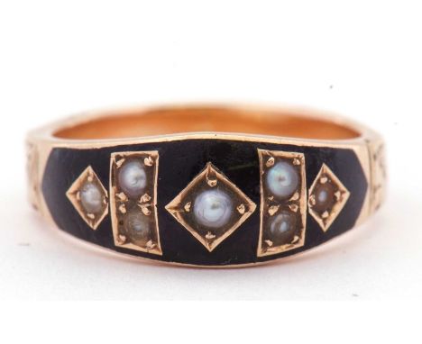 Victorian mourning ring, the top section set with seven small graduated seed pearls within a black enamel surround, the shank