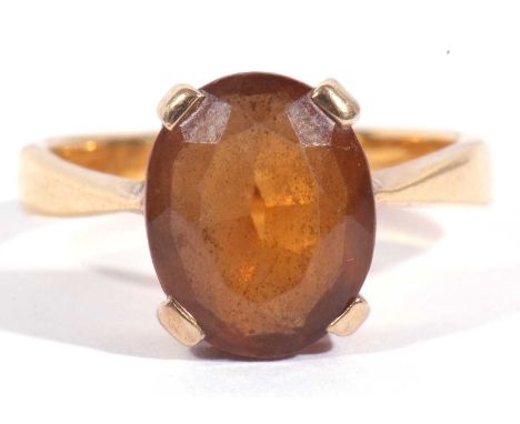 Citrine single stone ring of oval faceted shape, 10 x 8mm, basket set in a yellow metal mount, (marks rubbed), tests for 18ct