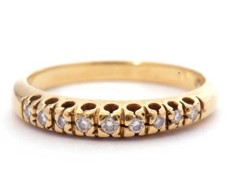 Diamond set half hoop ring, having nine small single cut diamonds, stamped 750, size M