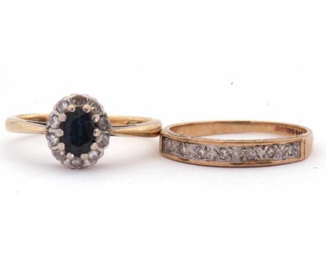 18ct gold sapphire and diamond cluster ring, the oval faceted sapphire, 6 x 4mm, raised above a small single cut diamond surr