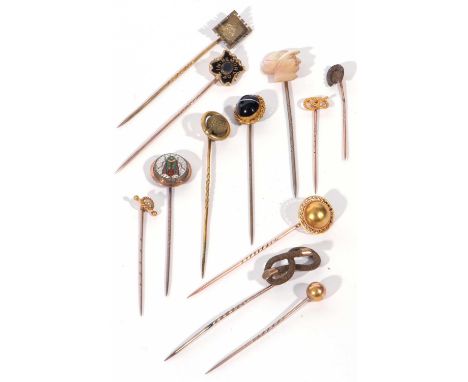 Collection of antique stick pins to include micro mosaic beetle finial example, a mother of pearl carved jockey's head, bande