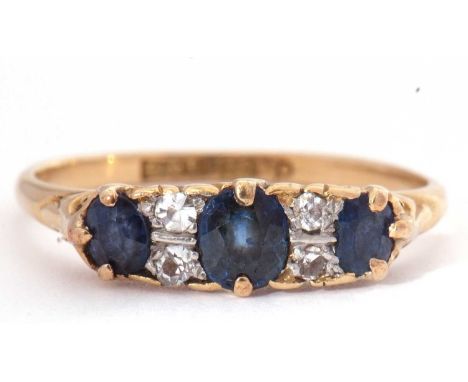 Sapphire and diamond seven stone ring, a design with three graduated oval faceted sapphires, highlighted between with four sm