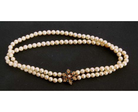 Double row cultured pearl choker style necklace of uniform size (6mm) to a 9ct gold sapphire and seed pearl cluster clasp, 15