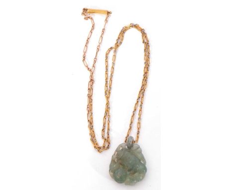 Carved jade pendant on a yellow metal chain, a 9ct stamped pin brooch, two 9ct stamped dress studs, a yellow metal cross pend