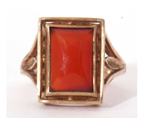 Carnelian set ring, the rectangular shaped carnelian panel framed between pierced shoulders, stamped 9ct, size L/M