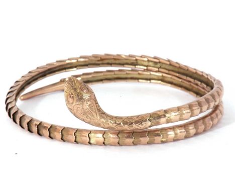 Vintage steel core and 9ct gold serpent bangle, the engraved snakes head and neck joined to a chased and polished coiled link