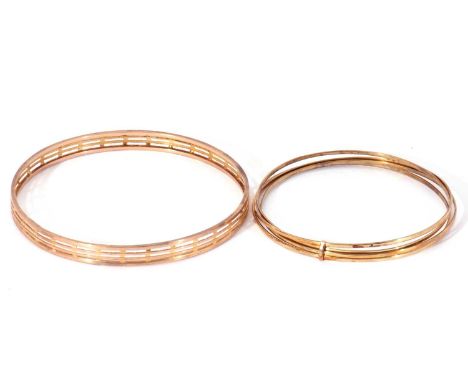 Large bangle with a pierced geometric design, 8cm diam, stamped 9ct, together with a bangle with four thin bands joined by a 