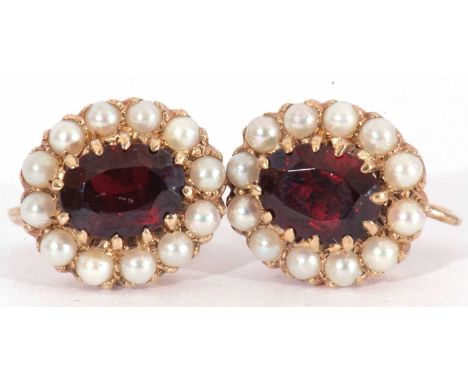 Pair of garnet and seed pearl cluster earrings with screw fittings, stamped 9ct