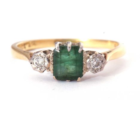 Emerald and diamond three stone ring, the square cut emerald 6mm square, flanked by two small diamonds, each in illusion sett