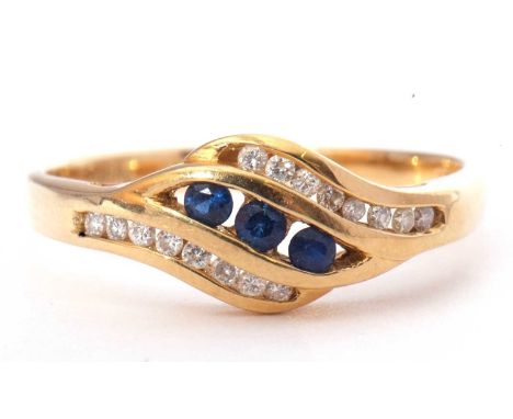 Sapphire and diamond cross-over style ring, centring three round faceted sapphires, channel set, between bands of small diamo