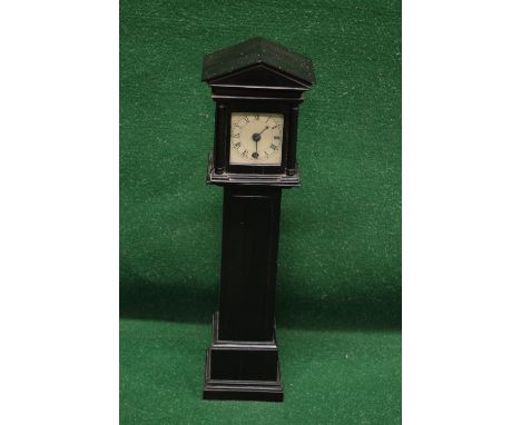 Unnamed miniature longcase clock, the cream face having black Roman Numerals and silvered metal hands, contained in wooden ca