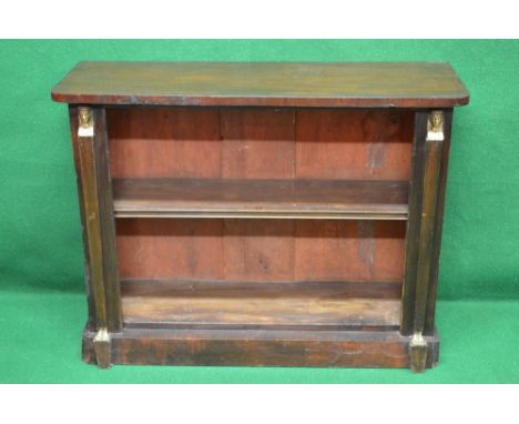 William IV mahogany bookcase with rounded corners and single fixed shelf flanked by Egyptian Pharaoh mounts, standing on plin