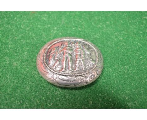 Continental white metal snuff box of oval form having engraved border and embossed lid depicting musketeers - 2.5" wide
