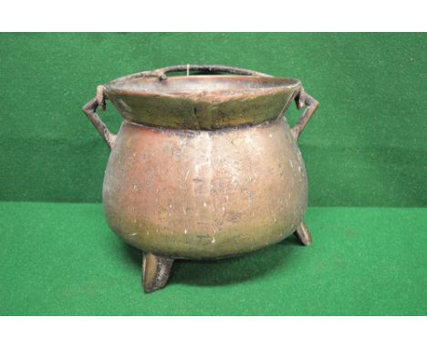18th/19th century bronze cauldron with iron swing handle and standing on three outward splaying legs - 10" tall