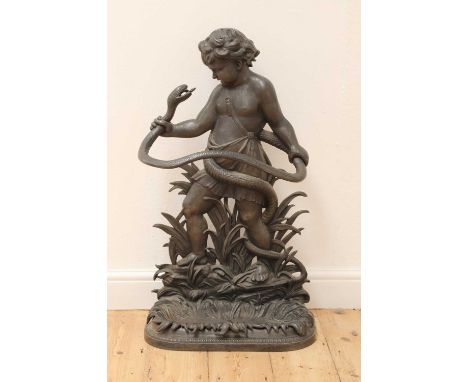 A cast iron stick or umbrella stand, 19th century, modelled in the form of a cherub wrestling a serpent, with a detachable dr