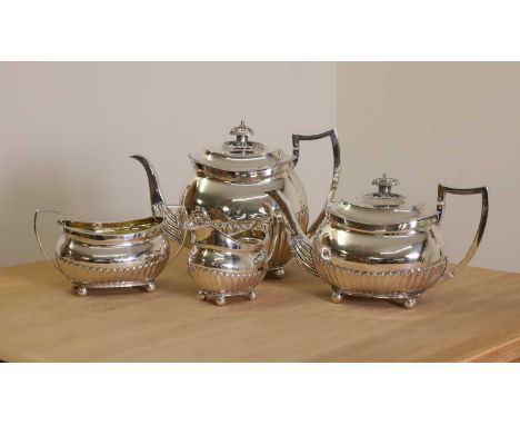 A George III four-piece silver tea service, by Thomas Wallis, London 1808 and 1809, each with part-fluted decoration, teapot 