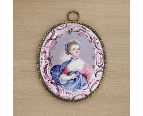 An English enamel miniature portrait medallion,mid-18th century, possibly Queen Charlotte depicted half-length in a blue and 