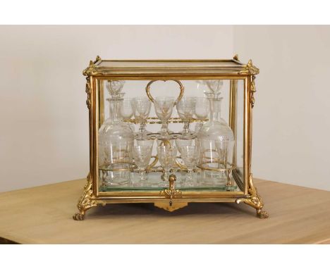 A French Napoleon III ormolu and glass cave à liqueur,19th century, opening to reveal a fitted interior with sixteen glasses 