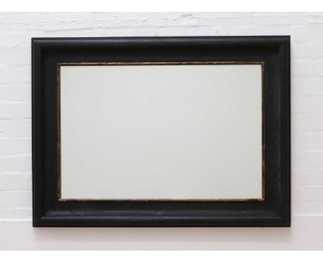 A rectangular mirror by OKA, of recent manufacture, the bevelled plate within an ebonised and parcel-gilt frame,84cm wide117c