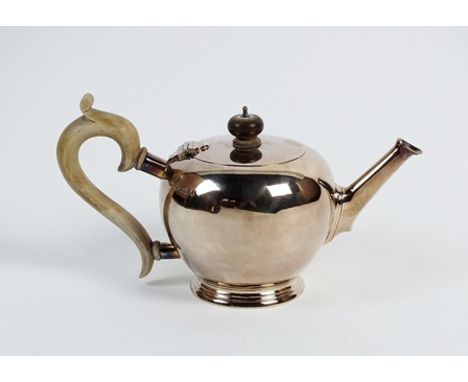 A silver bullet shaped teapot, Mappin & Webb, London 1935, of plain polished form with turned wood handle and finial, raised 