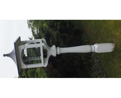 A contemporary bird table of Japanese lantern design raised on turned baluster support, white painted wood with lead effect p