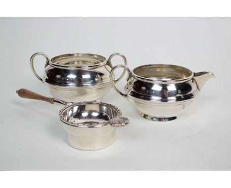 A silver sugar bowl and cream jug, S.W. Smith & Co, Birmingham 1918, each piece of squat circular from with reeded band to th